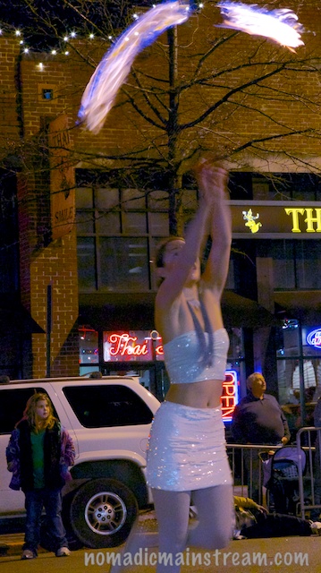 This woman is marching, looking straight up, and twirling firebrands.  I'm impressed.