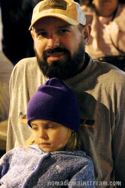 Father and daughter watch the parade next to me.