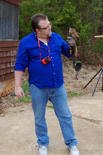 This participant enjoys meeting Buddy, an Eastern Screech Owl