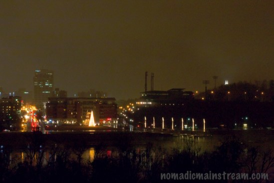The lighted tree reflects merrily on the water